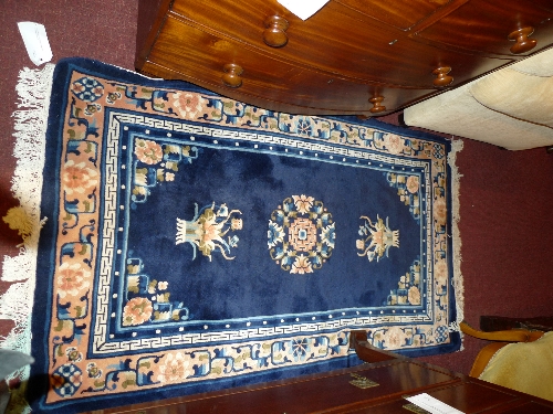 A Chinese rug with a midnight blue ground surrounded by borders