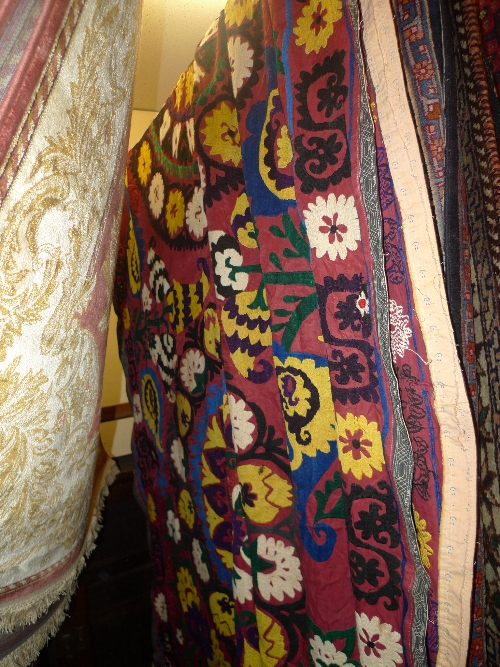 A fine hand knotted Uzbekistan Suzanie carpet with repeating floral motifs within stylized floral