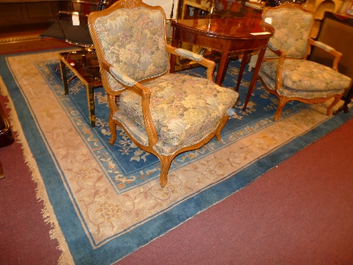 A large Chinese carpet with a blue field surrounded by three borders