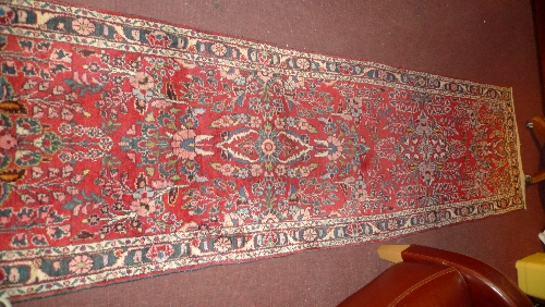 A hand knotted Persian Hamadan runner the red field with all over foliate design