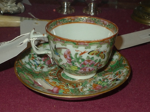 A mid-C19th Chinese cup and saucer decorated in the famille rose palette