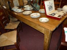 A C19th country pine kitchen table on heavy square section supports