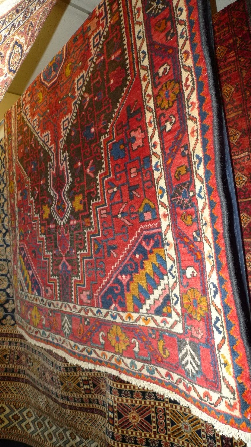 A fine North West Persian Hamadan rug 183cm x 105cm central pole medallion on a rouge field within