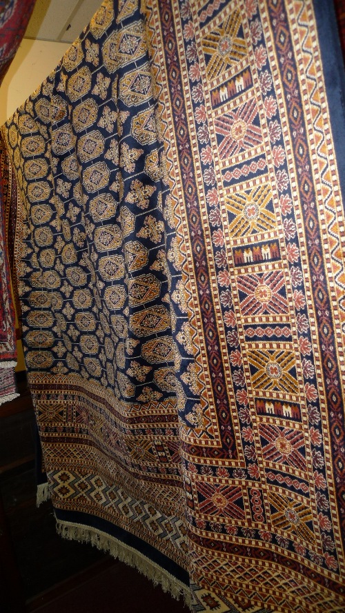 A Persian design Bokhara carpet the blue field with geometric design 280cm x 200cm