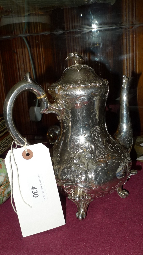 A Victorian engraved silver plated coffee pot with leafy `C` scroll decoration