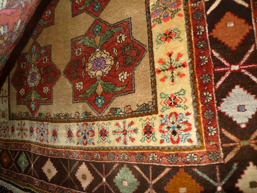 A fine North West Persian Bidjar rug 222cm x 116cm repeating panel floral motifs on a camel field