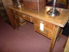 A C19th mahogany and crossbanded kneehole desk fitted five drawers on square tapered supports