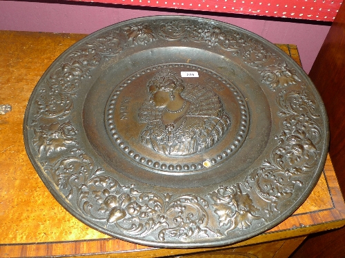 A pair of bronzed wall chargers with Monarch embossed centres and foliate bonders