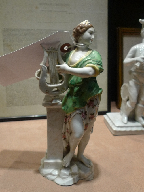 A C19th continental porcelain figure group classical maiden playing lyre