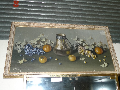 An oil on canvas still life fruit and ewer signed lower left in gilt frame