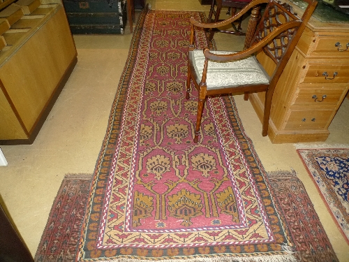 A hand knotted Hamadam runner red fields with repeating foliate decoration