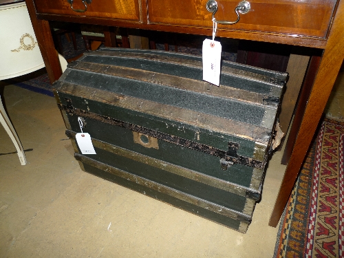 A dome top canvas and wrought iron bound seaman chest