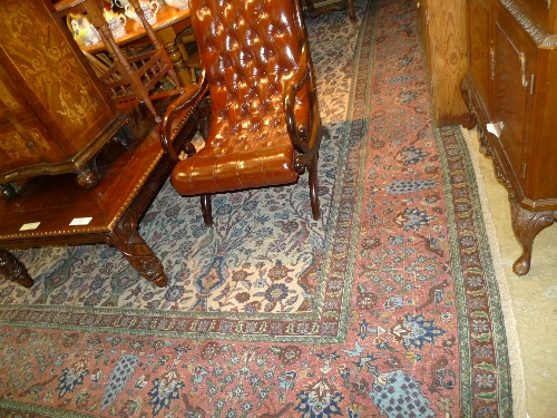 A hand knotted Persian carpet with terracotta field with bird decoration within brown border (a/f)
