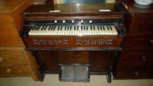 A mahogany foot pumped organ