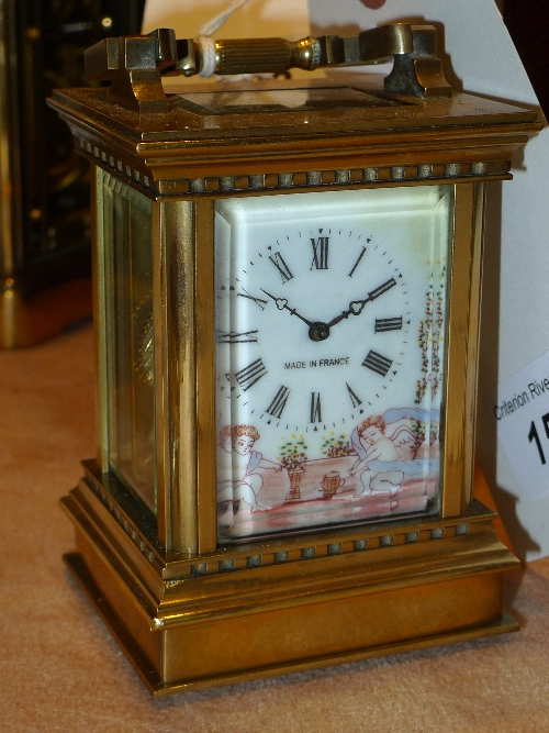 A brass carriage clock with enamel dial