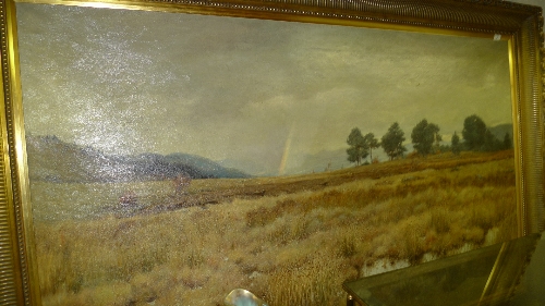 A large oil on canvas rural landscape with rainbow in  the distance signed lower right within gilt