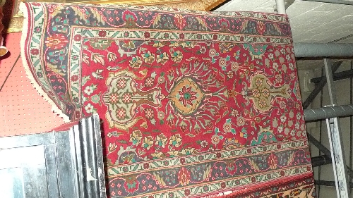 A fine North West Persian Tabriz runner 460cm x 93cm repeating floral motifs on a rouge field within