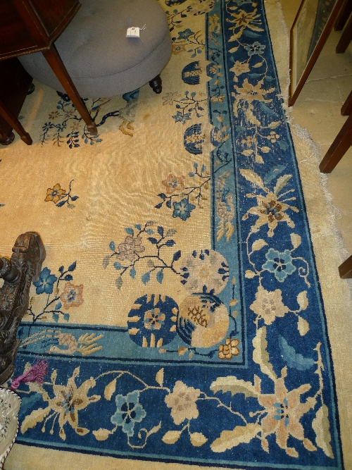 A hand knotted Nepalese carpet the beige ground with foliate spray decoration