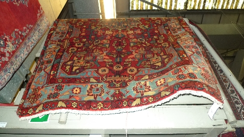 A fine North West Persian Nahawand rug 228cm x 147cm the red field bearing a petal form medallion