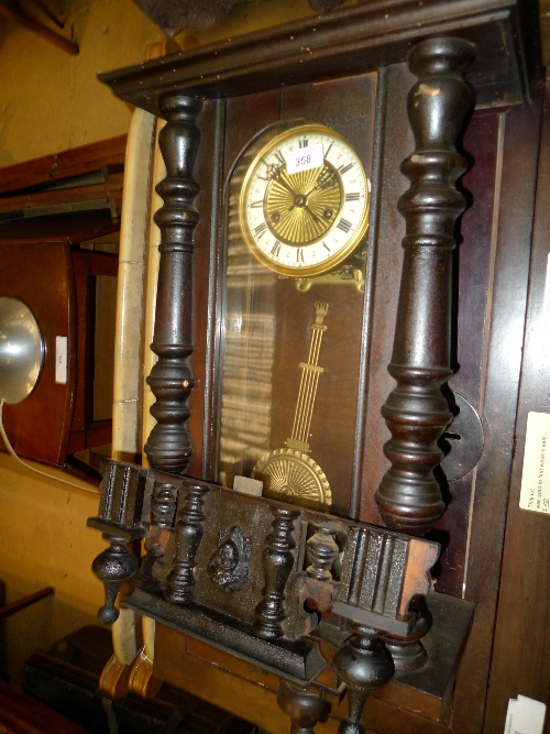 A wall clock with carved frame and Roman numeral dial