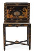 A Chinese black lacquer and gilt decorated cabinet on stand, late 18th/early 19th century, the