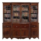 A Regency mahogany breakfront library bookcase, circa 1815, moulded cornice, above a central pair