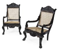 A pair of Ceylonese carved ebony bergere armchairs, circa 1850, each arched rectangular back