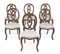 A set of twelve Victorian rosewood dining chairs, circa 1870, composed of two sets of six chairs of