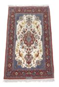 An Isfahan rug, signed for the Seirafian workshop, the central blue and crimson medallion within an