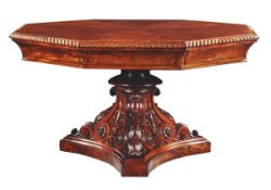 A George IV revolving octagonal mahogany library table, circa 1825, in the manner of  Gillows of