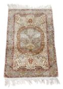 A Hereke rug, profusely decorated throughout with branches of flowers, the central sky blue reserve