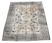 A Kashan carpet, signed for the Esfehanian workshop, the cream field decorated throughout with blue