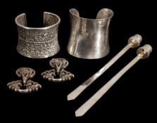 A group of silver objects, 19th century, comprising to cuffs, one plain, the other decorated with