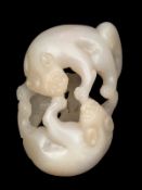 A small Chinese jade carving of two cats, 18th century , coiled about each other, with long