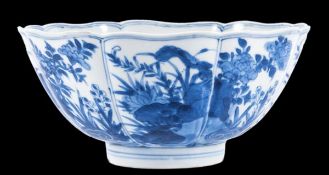 A Chinese blue and white bowl, Kangxi period , with fluted sides, flared mouth and foliated rim,