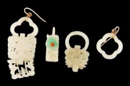 Four Chinese jade earrings, Qing dynasty , differently carved with floral designs and foliage