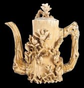 A Chinese ivory coffee pot and cover, 19th century, carved as a wooden stump form with handle and