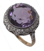 An amethyst and diamond dress ring, the round cut amethyst, estimated to weigh 10.83 carats within