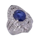 A sapphire and diamond dress ring, the marquise shaped pierced panel with a central sapphire and