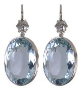 A pair of diamond and aquamarine ear pendents, the collet set oval cut aquamarines, estimated to