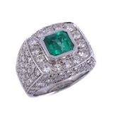 An emerald and diamond squared cluster dress ring, the central step cut emerald, estimated 1.49