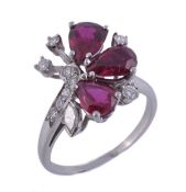 A ruby and diamond ring, set with three pear shaped rubies and brilliant cut and eight cut diamond