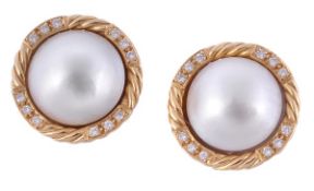 A pair of mabe pearl and diamond ear studs, the mabe pearls within an 18 carat gold ropetwist