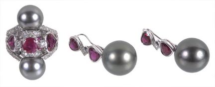 A black cultured pearl and ruby ring with a matching pair of ear pendents, the ring set with a