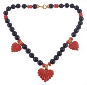 A coral and onyx bead necklace, the onyx beads with intermittent faceted coral (corallium rubrum)