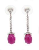 A pair of ruby and diamond earpendents, the oval cabochon ruby terminals with brilliant cut diamond