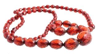 A faceted amber bead necklace, the graduated amber beads to a hidden amber clasp, beads 7mm to