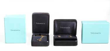 A pair of 18 carat gold heart shaped ear studs and pendant by Elsa Peretti for Tiffany & Co, the