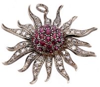 A diamond and ruby flower head pendant, the pointed petals set with rose cut diamonds to a ruby set