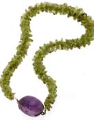 A peridot and amethyst necklace, the necklace consisting of tumbled beads of peridot, to a carved